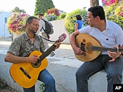 Thabet Graia (R) and Talel Aleli (L), both 32, singing in the Tunis suburb of Sidi Bou Said.