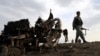 Afghan security forces gather at the site of Monday's attack near the Bagram Air Base, north of Kabul, Afghanistan, April 9, 2019.