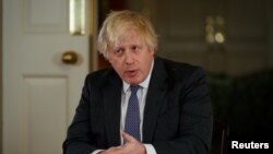 British Prime Minister Boris Johnson gestures as he records an address to the nation to provide an update on the booster vaccine COVID-19 program, at Downing Street, London, Britain, Dec. 12, 2021.