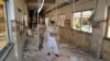 FILE - A Pakistani paramilitary soldier and a nurse walk through a corridor at the Bolan Medical complex damaged by an attack claimed by the Sunni militant group Lashkar-e-Jhangvi, in Quetta, Pakistan, June 16, 2013. Masroor Nawaz Jhangvi, son of Lashkar-e-Jhangvi's slain founder, has won the Jhang district by-election for a seat in the Punjab Assembly.