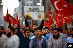 Protesters, some holding Turkish flags, chant slogans during a demonstration in Istanbul against the move of the U.S. embassy from Tel Aviv to Jerusalem, May 14, 2018.