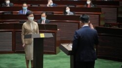 Newly elected pro-Beijing lawmaker Vincent Cheng Wing-shun, right, takes his oath in front of Chief Executive Carrie Lam during the oath-taking ceremony of the legislative council in Hong Kong, Monday, Jan. 3, 2022. (AP Photo/Kin Cheung)