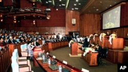 Empty seats, right side, which is believed to be sited by opposition of Cambodia National Rescue Party's parliamentary as Prime Minister Hun Sen, rear center, sits in the session hall of National Assembly, file photo. 