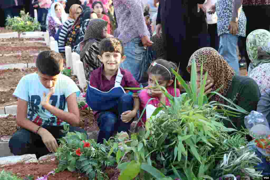 Displaced Afrin people visit the graves of their beloved ones in the eid