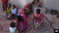 FILE - An Afghan family is seen in a temporary home in a camp for internally displaced persons in Kabul, Afghanistan, May 30, 2016.