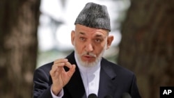 Afghan President Hamid Karzai is seen speaking during a press conference at the presidential palace in Kabul August 24, 2013.