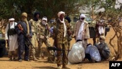 FILE - Members of an armed group are shown in Kidal, Mali, July 13, 2016. Clashes were reported in the restive northern city between pro-government and former rebel groups, both based there since February.