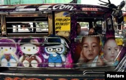 FILE - A "jeepney" adorned with colorful pop culture characters is photographed on a main thoroughfare in Quezon City, metro Manila, Philippines, May 29, 2017.