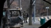 FILE - Soldiers are seen though a bus, which was burned during clashes, as they patrol a street near the central square blocked by Kazakhstan troops and police in Almaty, Kazakhstan, Jan. 10, 2022. 