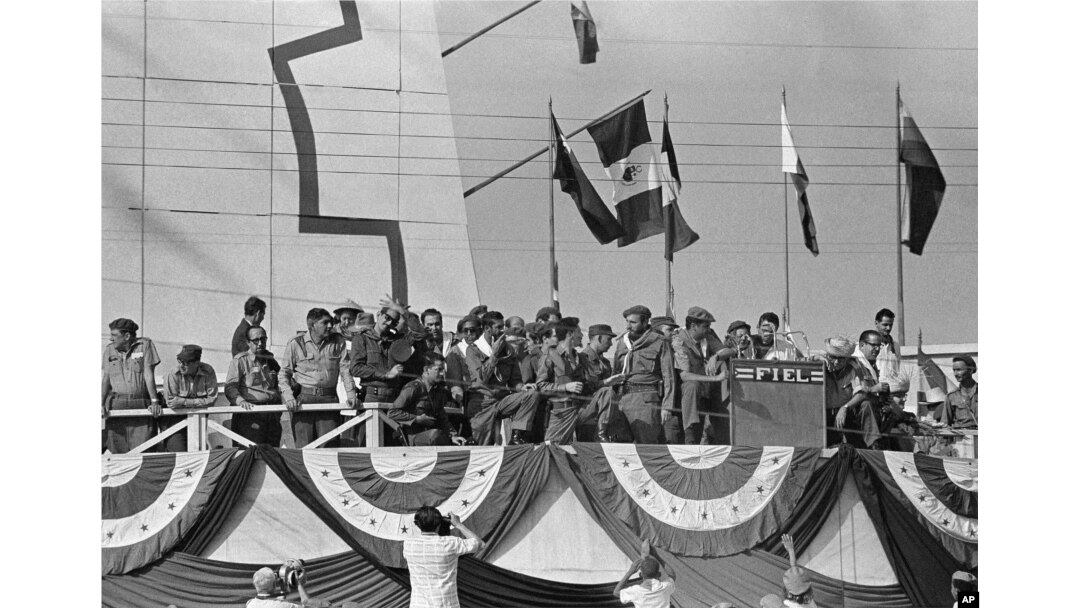 Cuba’s Prime Minister Fidel Castro, center, talks with soldier bodyguards while watching May Day parade in Havana May 1, 1961.