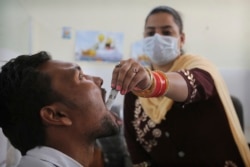 In this Thursday, Oct. 31, 2019, photo, a medic administers medicine to a recovering drug user at a de-addiction center in Kapurthala, in the northern Indian state of Punjab. (AP Photo/Channi Anand)