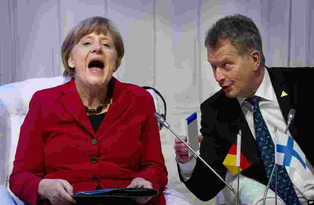 German Chancellor Angela Merkel, laughs talking to Finland&#39;s President Sauli Niinisto as they attend an informal plenary session on the last day of the Nuclear Security Summit (NSS) in The Hague, Netherlands.