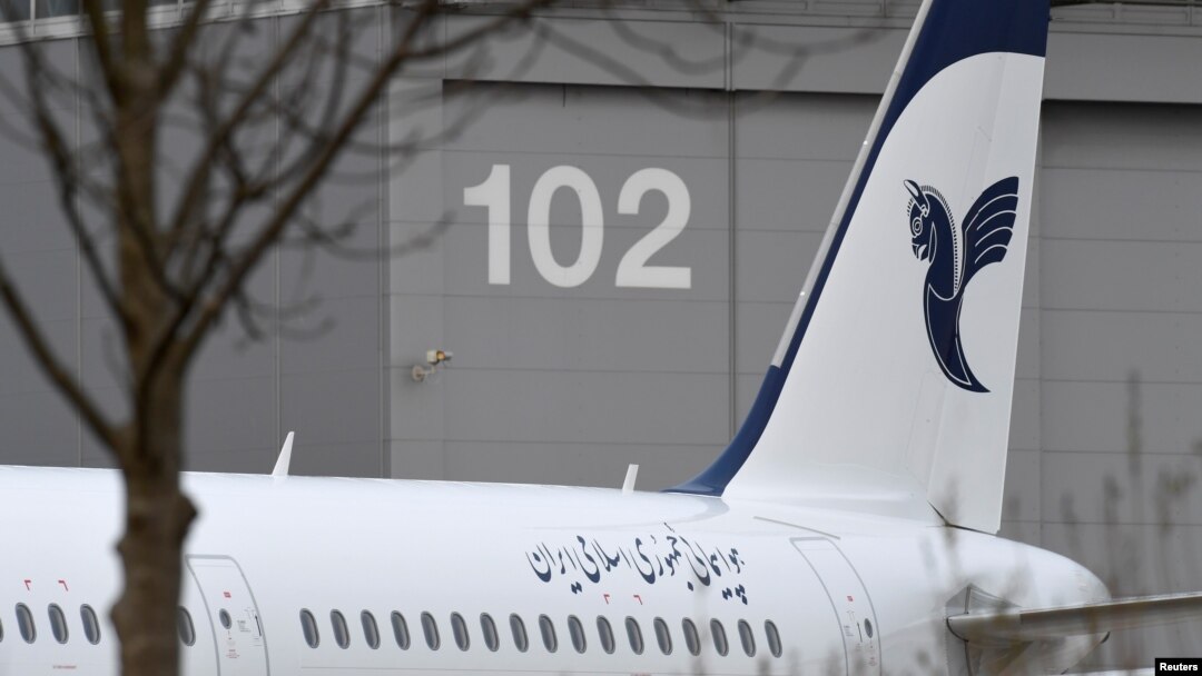 FILE - An Airbus with the description "The Airline of the Islamic Republic of Iran" is parked at the Airbus facility in Hamburg Finkenwerder, Dec. 19, 2016. Iran 's aviation body announced Sunday the cancelation of flights at some of the country's airports. 