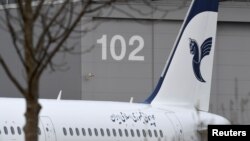 FILE - An Airbus with the description "The Airline of the Islamic Republic of Iran" is parked at the Airbus facility in Hamburg Finkenwerder, Dec. 19, 2016. Iran 's aviation body announced Sunday the cancelation of flights at some of the country's airports. 