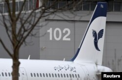 FILE - An Airbus A321 with the description "The Airline of the Islamic Republic of Iran" below the tail fin is parked at the Airbus facility in Hamburg Finkenwerder, Germany, Dec. 19, 2016.