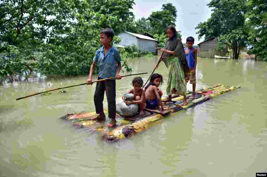 Villagers row a temporary raft through the flood-affected Mayong village in Morigaon district, in the northeastern state of Assam, India.