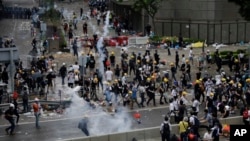Riot police fire tear gas to protesters outside the Legislative Council in Hong Kong, June 12, 2019. 