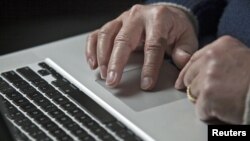 A U.S. cyber warfare expert works on his laptop computer, December 1, 2011.