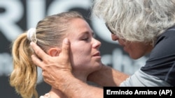 Camila Giorgi of Italy is congratulated by her father Sergio Giorgi after winning the women’s final at a tournament in the Netherlands, June 2015. (AP Photo/Ermindo Armino)