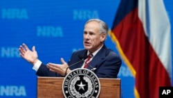 FILE - Governor Greg Abbott speaks at the National Rifle Association-Institute for Legislative Action Leadership Forum in Dallas, May 4, 2018. 