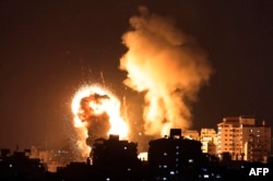 Fire rises from Israeli air strikes in the Gaza Strip, controlled by Hamas, on May 10, 2021. Israel launched the air strikes after a series of rockets fired by Hamas to answer the clashes in Jerusalem. (Photo by MAHMUD HAMS / AFP)