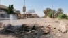 Pro-democracy protesters blocked roads with makeshift barricades and fires a day after the military seized power in a move widely denounced by the international community, in front of Mercy Care Hospital, in Khartoum, Sudan, Oct. 26, 2021. 