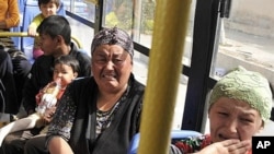 Uzbek women weep on a bus as it leaves the southern Kyrgyz city of Osh at the height of ethnic clashes in June 2010 (FILE PHOTO).