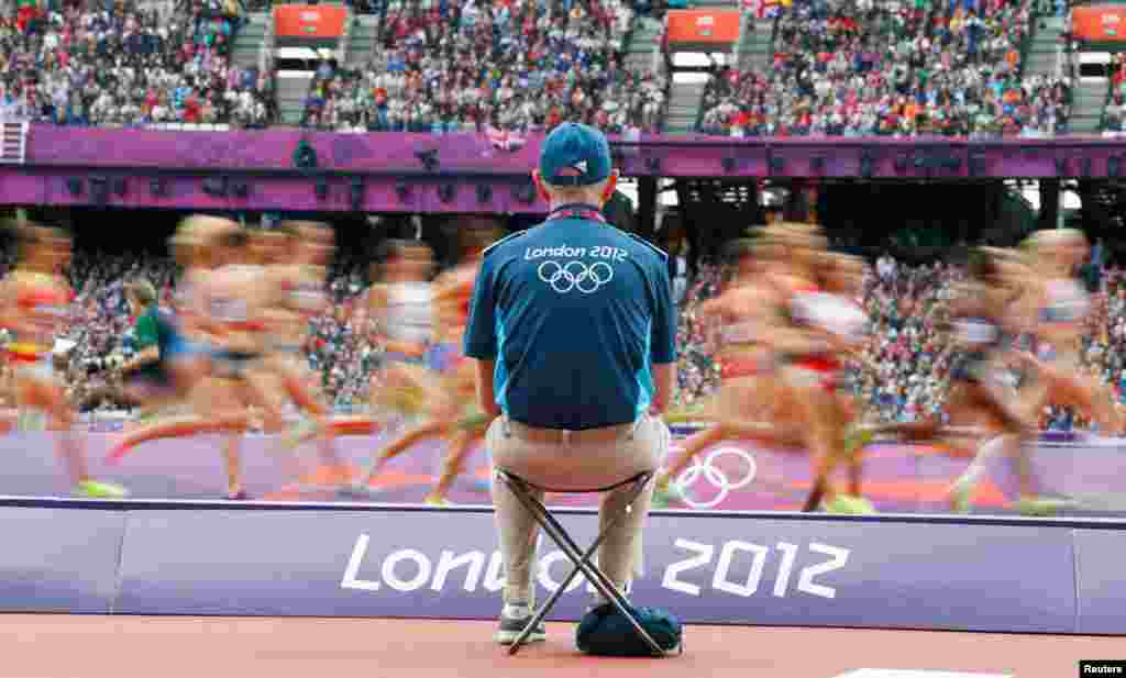 Competitors race in their women's 1500m heat at the Olympic Stadium.