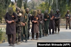 AFGHANISTAN -- Forces with Afghanistan's National Directorate Security (NDS) escort alleged Taliban fighters after they are presented to media in Jalalabad, January 23, 2019