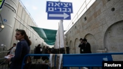 FILE - A sign pointing to the men's exit is seen at Rachel's Tomb in the West Bank town of Bethlehem, November 8, 2011.