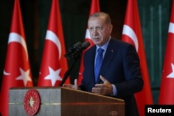 Turkey's President Tayyip Erdogan addresses Turkish Ambassadors during a meeting in Ankara, Turkey, Aug. 13, 2018.