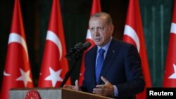 Turkey's President Tayyip Erdogan addresses Turkish Ambassadors during a meeting in Ankara, Turkey, Aug. 13, 2018. 