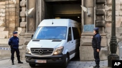 A police van believed to be carrying ousted Catalan president Carles Puigdemont leaves the Palace of Justice in Brussels, Friday, Nov. 17, 2017.