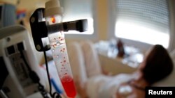 FILE - A patient receives chemotherapy treatment for breast cancer at the Antoine-Lacassagne Cancer Center in Nice July 26, 2012. 