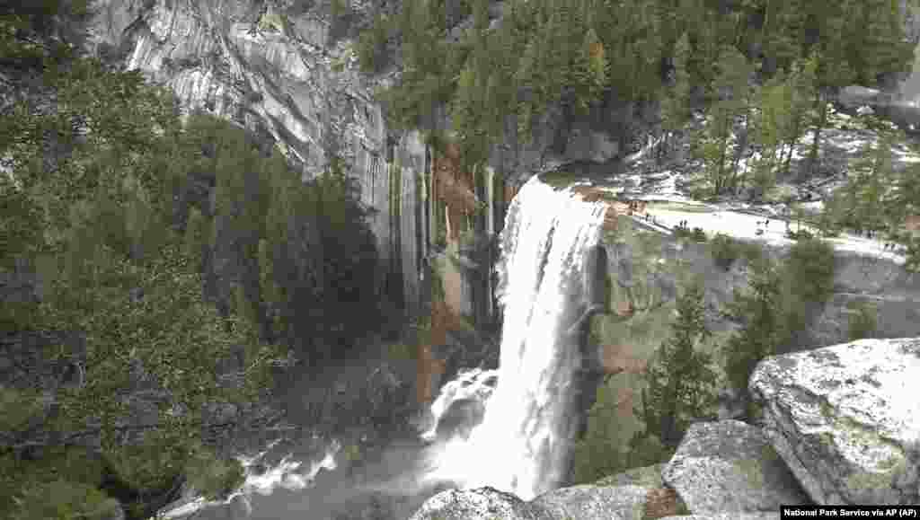 Water plunges 300 feet over Vernal Fall onto the Merced River in Yosemite National Park, California.