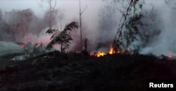 A view shows a lava fissure in Leilani Estates, Hawaii, May 9, 2018, in this still image taken from a social media video.