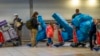 People line up to get on an overseas flight at OR Tambo International Airport in Johannesburg, South Africa, Nov. 26, 2021. 