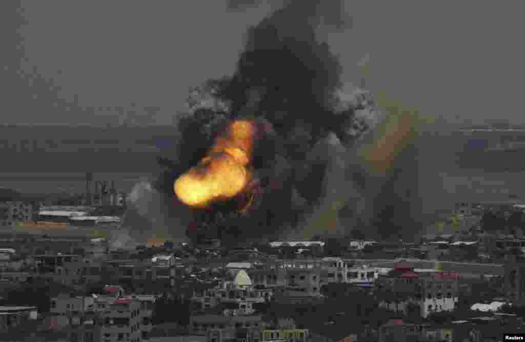 Smoke and flames are seen following what police said was an Israeli air strike in Rafah in the southern Gaza Strip. Israel bombarded dozens of targets in the Gaza Strip, stepping up what it said might become a long-term offensive against Islamist Hamas.