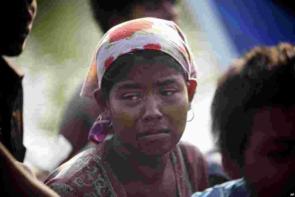 A rescued migrant weeps upon arrival in Simpang Tiga, Aceh province, Indonesia, May 20, 2015.