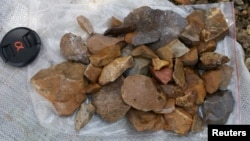 Surface-collected stone artifacts that were found lying scattered on the gravelly surface near Talepu on the Indonesian island of Sulawesi, are pictured in this undated handout photo, Jan. 13, 2016. 