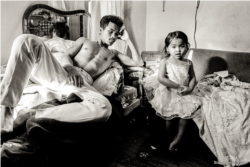 Ricky and his younger sister, Wendy, in their apartment in a Chicago housing building where dozens of Cambodian families lived in the 1990s.