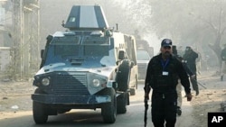 An armored car carries a U.S. consular employee, suspected in a shooting, leaves a court in Lahore, Pakistan, February 3, 2011