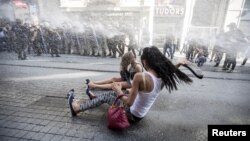 FILE - Riot police use a water cannon to disperse LGBT rights activist before a gay pride parade in central Istanbul, Turkey, June 28, 2015.