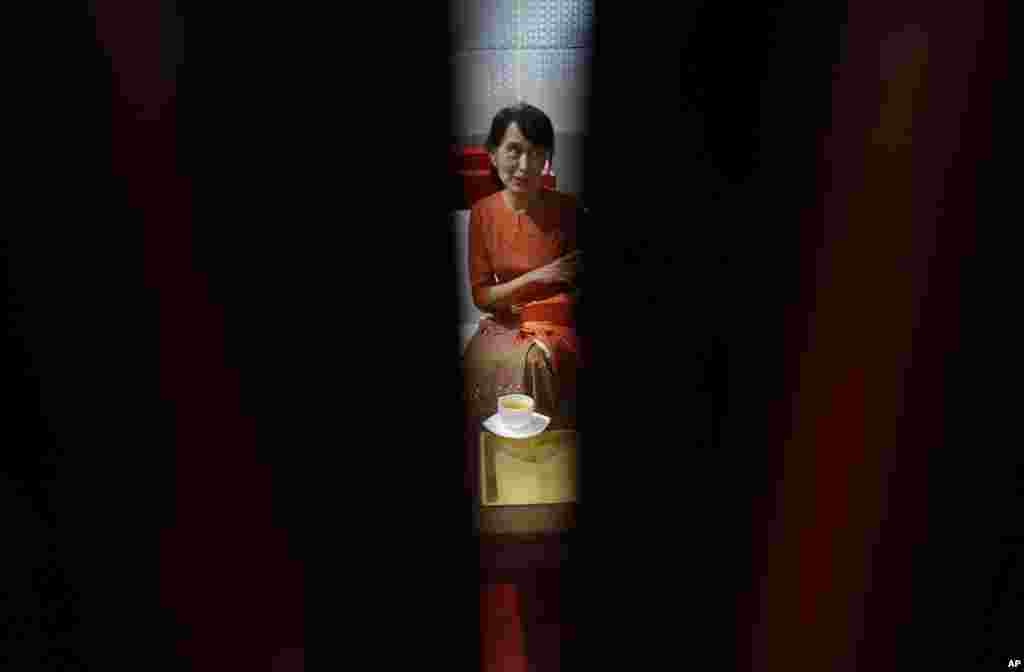 Burma's pro-democracy leader Aung San Suu Kyi has a cup of tea at the VIP lounge of Rangoon's airport as she waits for her flight to Bangkok, Thailand, May 29, 2012.