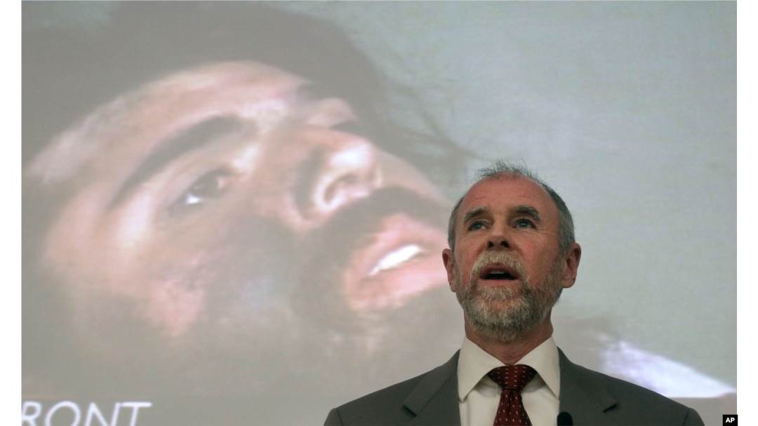 FILE - Frank Lindh is shown speaking to law students in front of a projected image of his son, John Walker Lindh, at the University of San Francisco in San Francisco, Feb. 16, 2011.