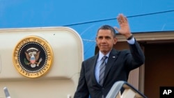 FILE - President Barack Obama waves as he gets off Air Force One upon his arrival at King Khalid International airport in Riyadh, Saudi Arabia, March 28, 2014. 