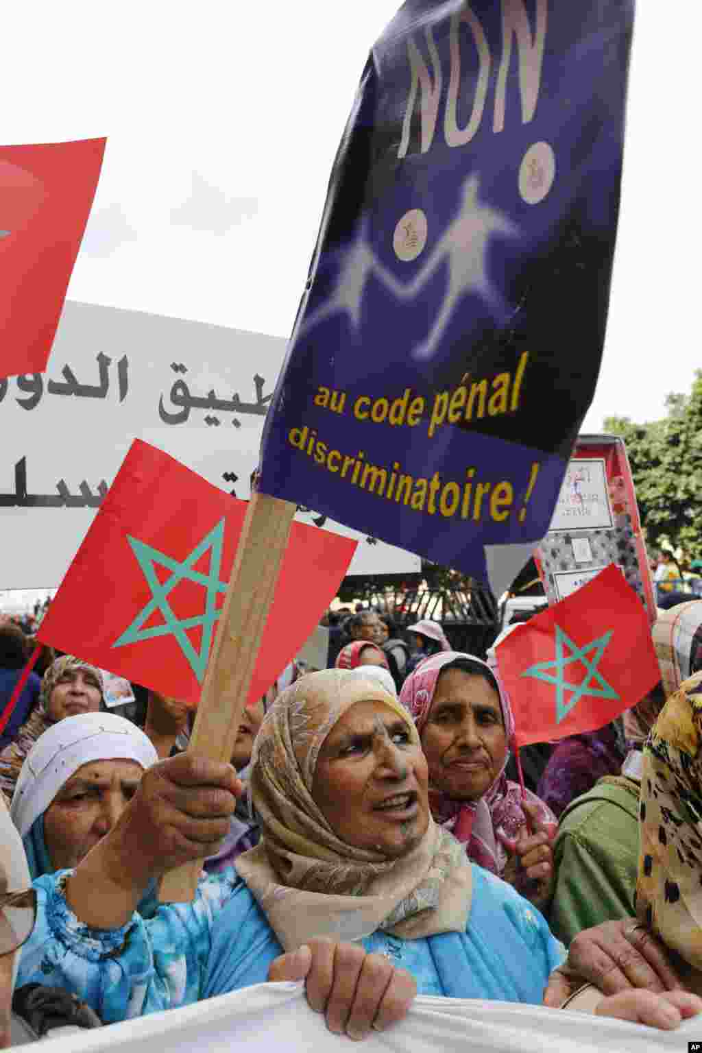 A Moroccan old woman shouts slogans as she holds a placard witch reads "No discriminatory penal code" during a march to mark International Women's Day in Rabat, Morocco, March 8, 2015.