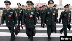 Military delegates arrive at the Great Hall of the People for a meeting ahead of China's annual session of parliament, in Beijing, March 4, 2018. 