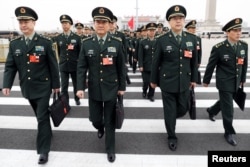 Military delegates arrive at the Great Hall of the People for a meeting ahead of China's annual session of parliament, in Beijing, March 4, 2018.