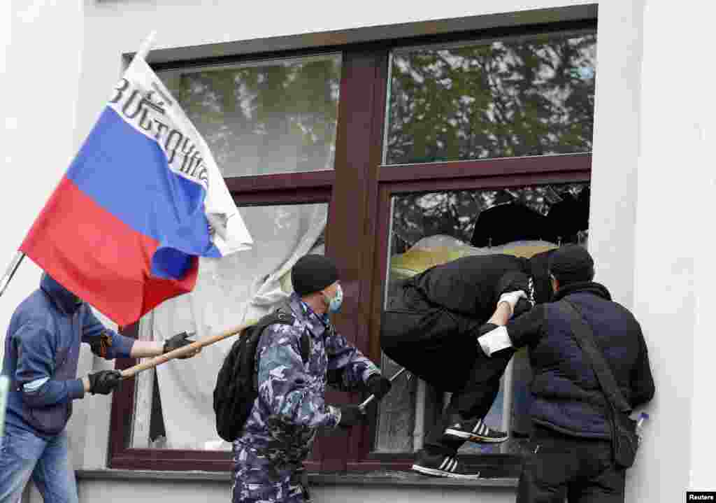 Pro-Russian activists attack the regional administration building in Luhansk, Ukraine, April 29, 2014.